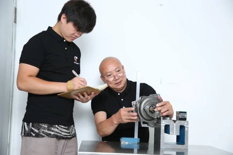 Technician measuring turbocharger turbine housing during failure diagnosis
